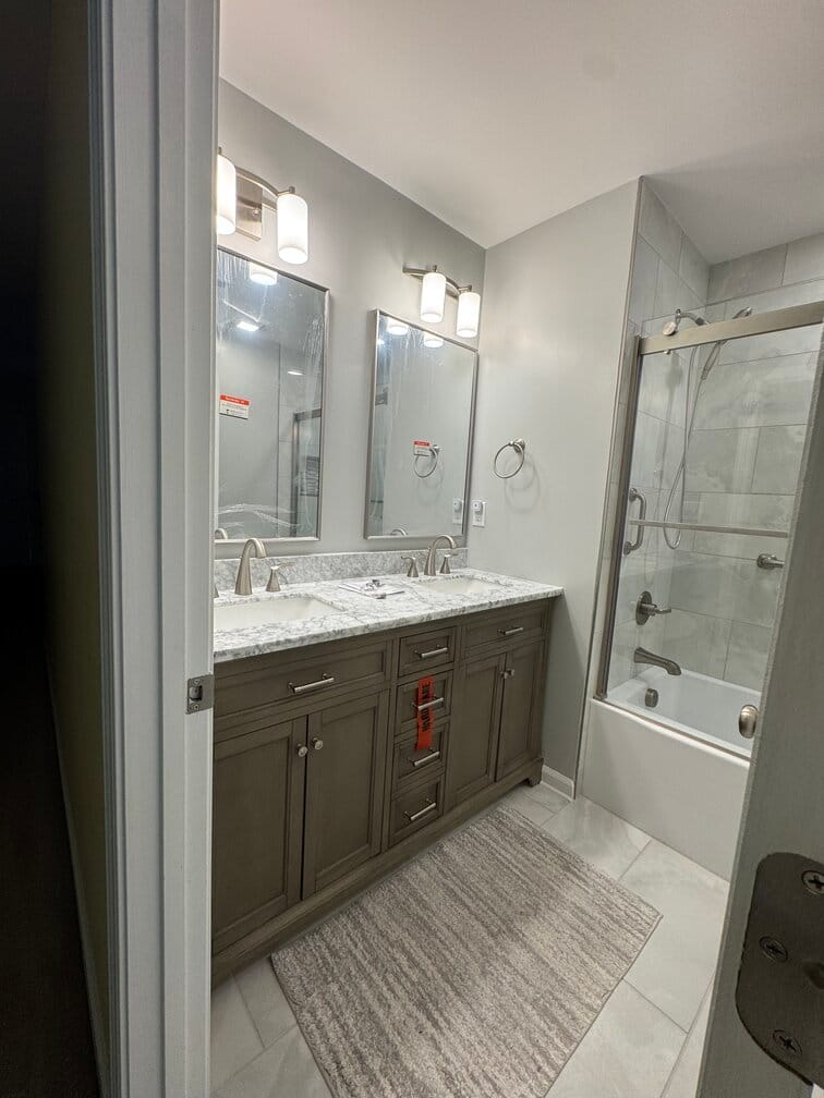 Completed bathroom remodel in Cary NC with white tile brown cabinets