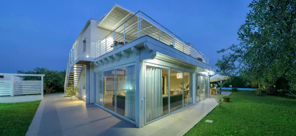 Two-story Accessory Dwelling Unit (ADU) with rooftop deck and full-height glass walls.